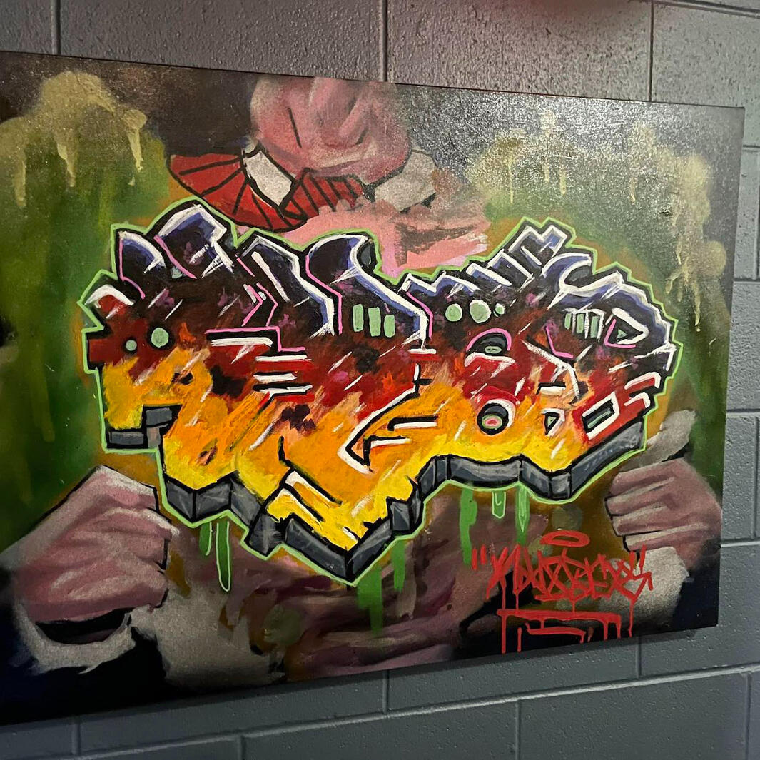 Original urban contemporary fine art canvas painting featuring 3D graffiti style lettering bursting from a chest by VanGalder Murals